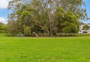 Fenced on-site dog park with agility equipment