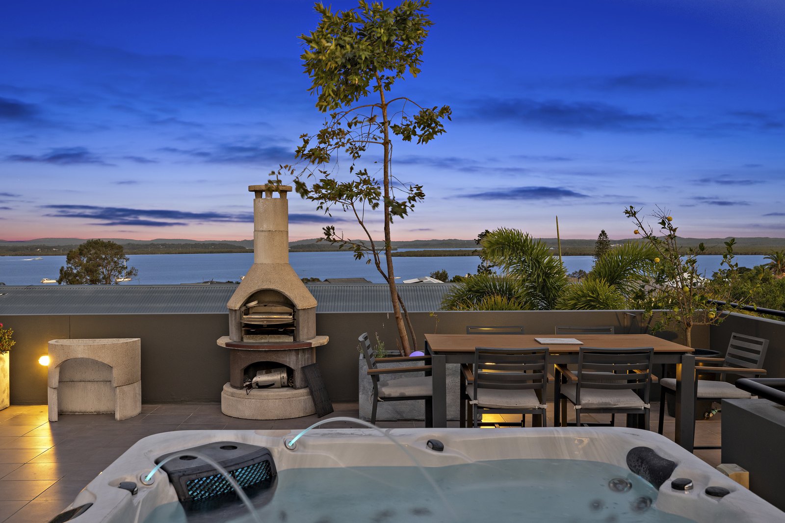 Rooftop pizza oven and spa at dusk